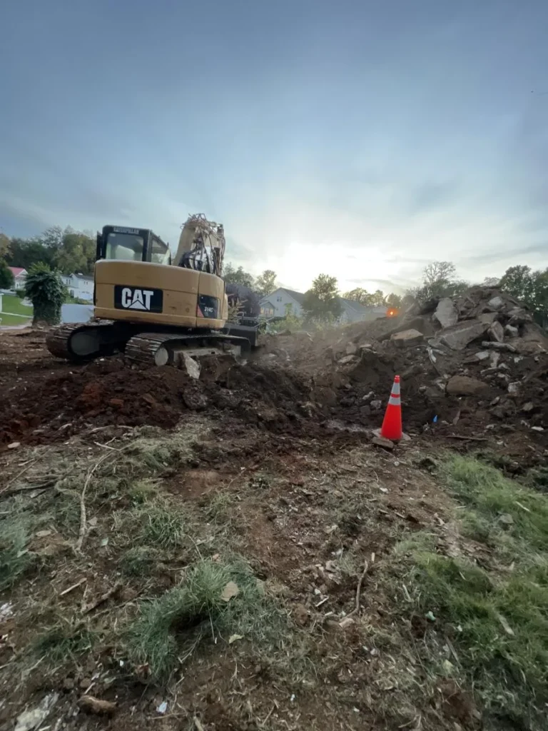 Triple Crown excavator performing demolition services on a house