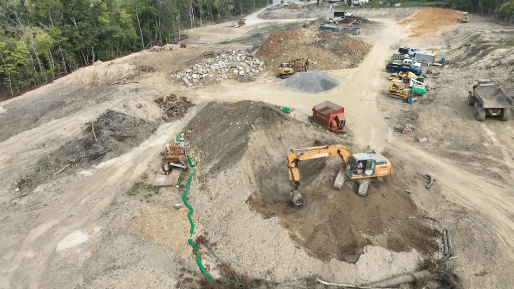Two excavators excavating land on a large construction site for excavation services