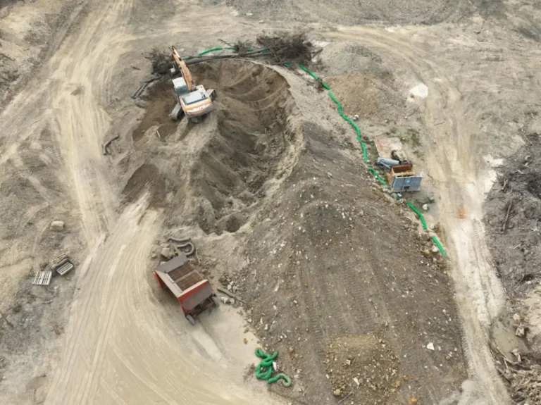Top-down view of an excavator operating in an excavation site