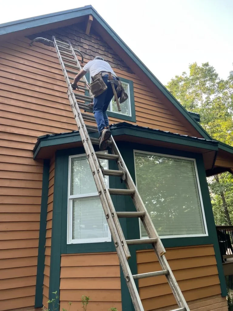 Triple Crown construction worker climbing a ladder during a building project, representing the About section of Triple Crown