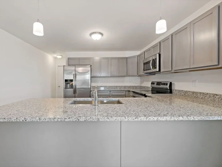 Custom-built kitchen with white and grey color scheme