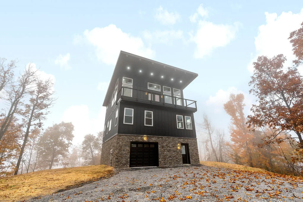 Exterior view of a black 3-story custom-built house for custom home building