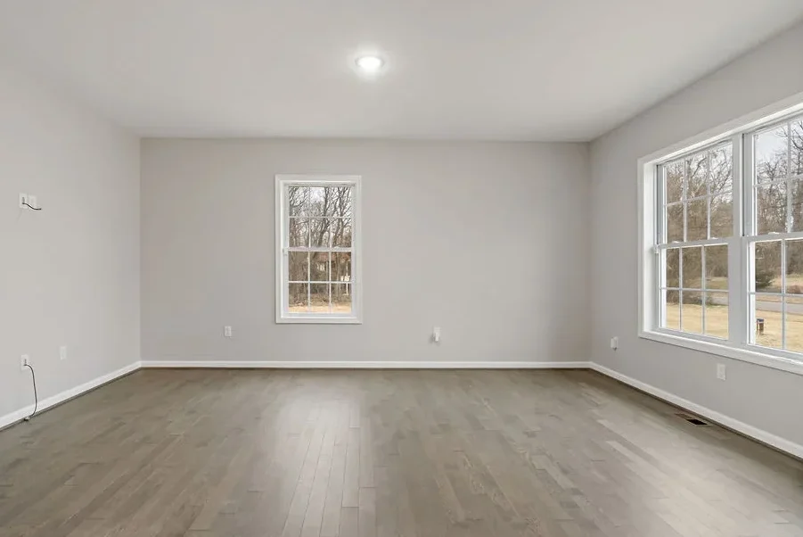 Empty white room with flooring and painting renovations completed by Triple Crown